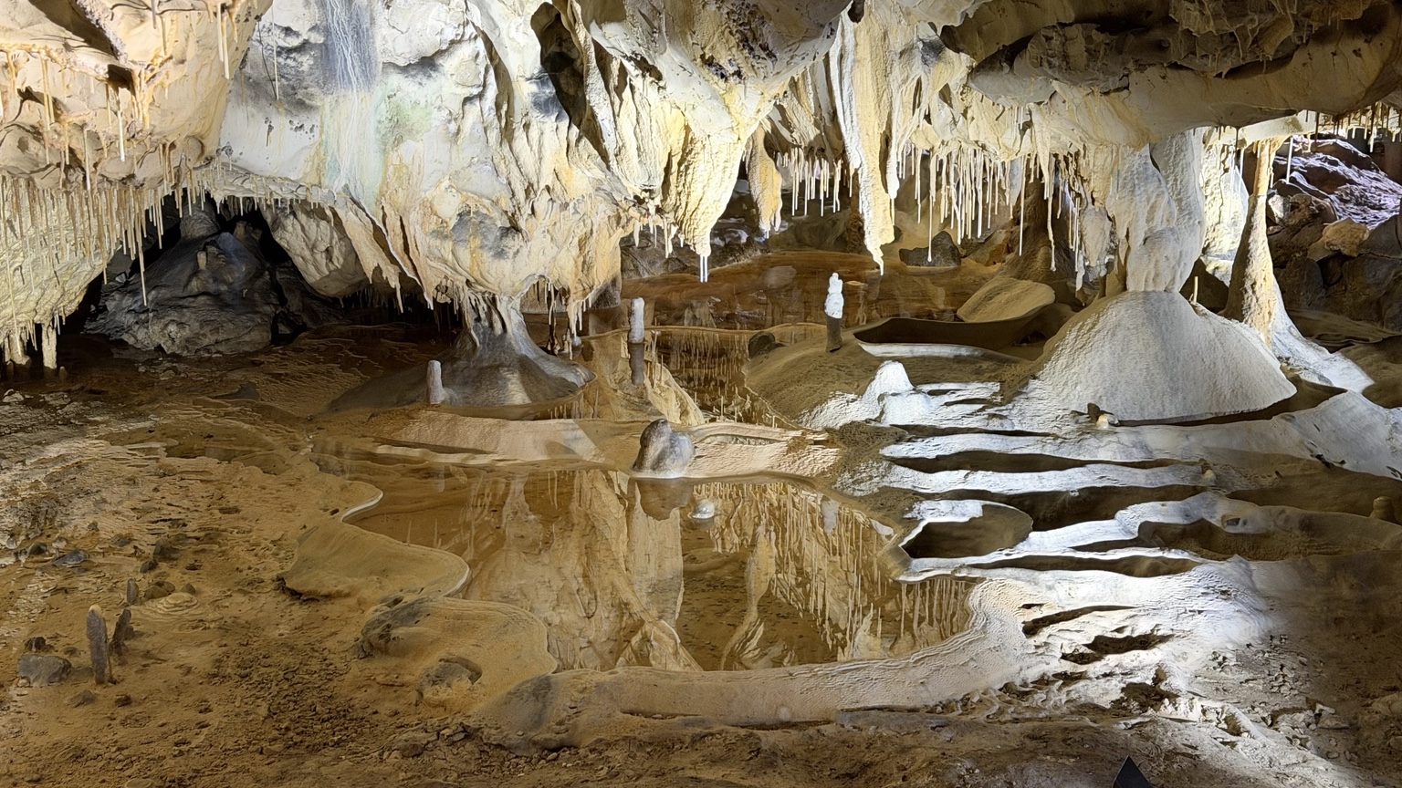 Waterbekkens weerspiegelen stalactieten en stalagmieten